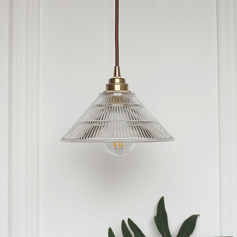 Enhance Your Dining Room with Industrial Elegance: The Brass Cone Pendant with Clear Ribbed Glass