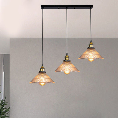 Illuminate Your Dining Room with Industrial Elegance: The 3-Light Brass Cone Pendant with Ribbed Glass
